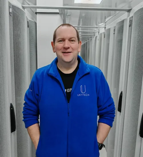 UK1tech team member in front of servers